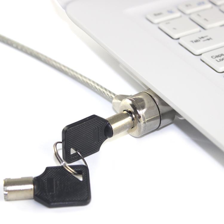 Keyed security cable lock attached to a laptop